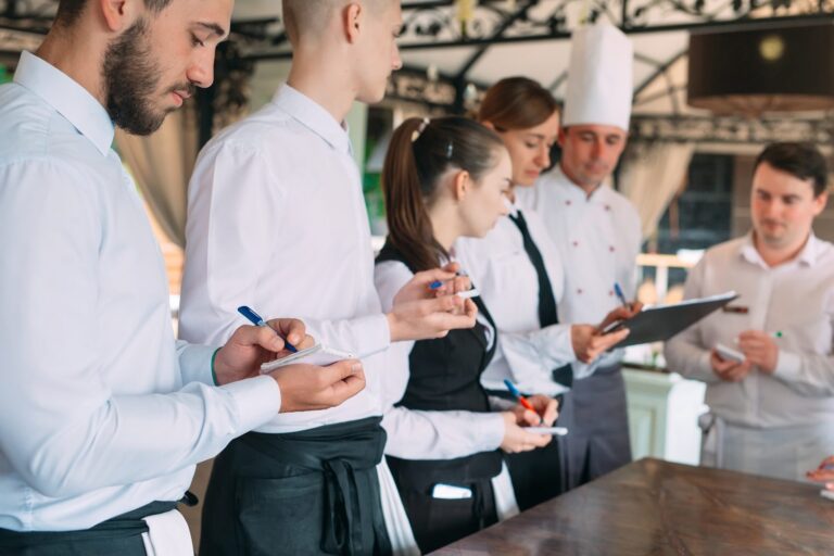 A restaurant manager with his team on the terrace, where reducing employee turnover in hospitality begins